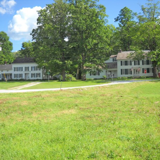 When Norman’s first studio in Vermont burned down in 1943, him, his wife Mary, and sons Jarvis, Thomas, and Peter moved to this 1792 Colonial house on the West Arlington, Village Green. The Edgerton family, whose members appeared in many paintings, lived in the second of the “Twin Houses” at left. Norman’s close friend Jim Edgerton appears twice in food package from home behind the first two men.